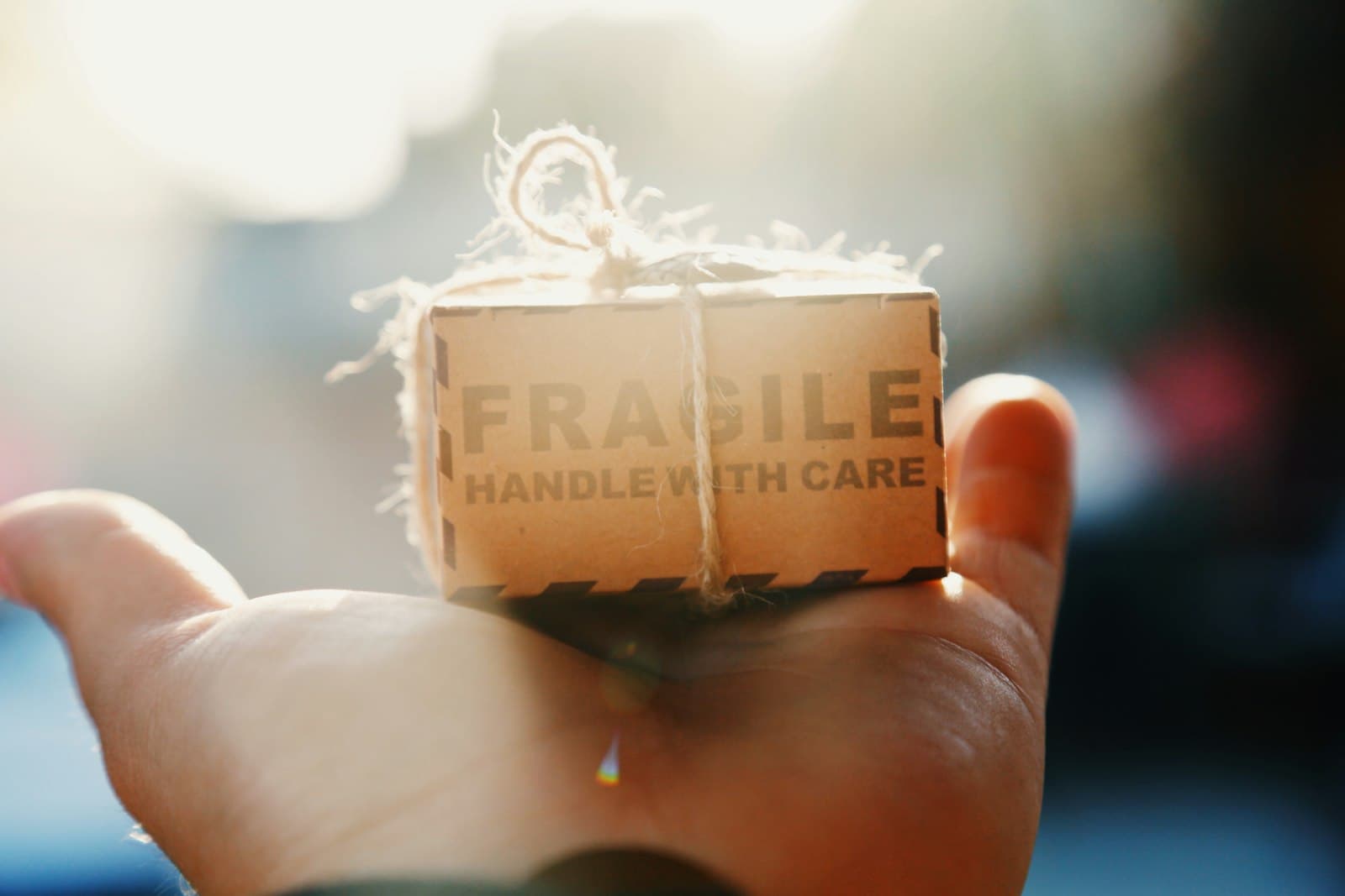 A small parcel marked fragile, resting on an open palm