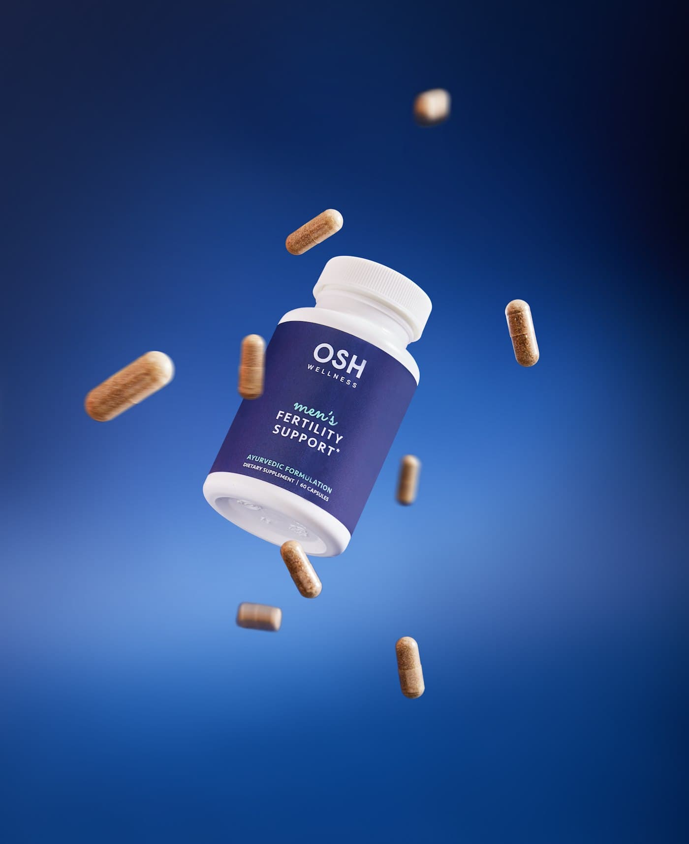 A supplement bottle with capsules floating against a blue background